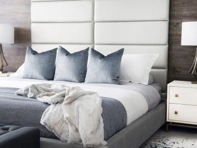 In the bedroom design of this Ajax home, the full-height headboard made of vant system panels is another example of a custom look created without spending a lot of money