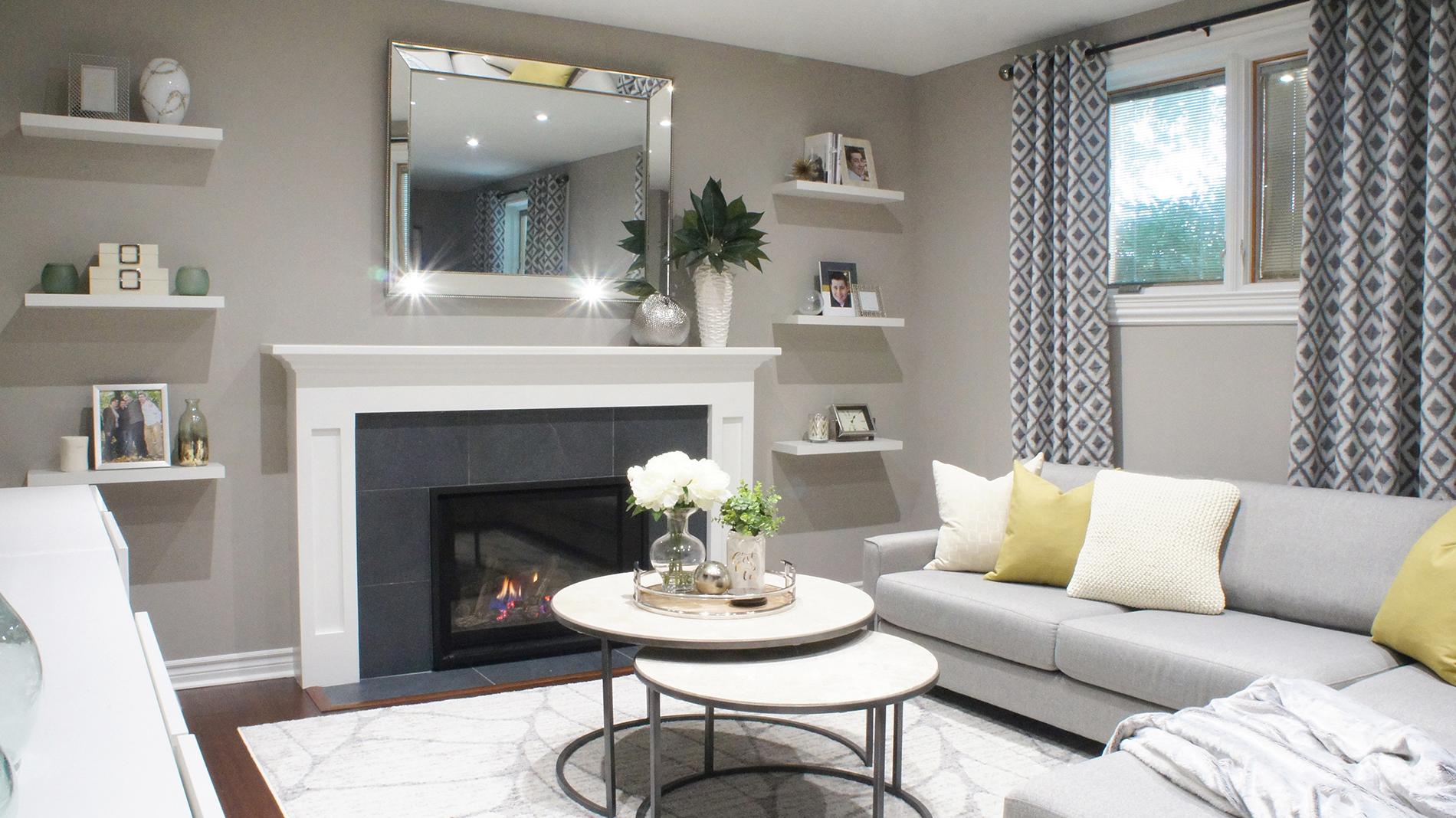 We brought a bit of fun to this Etobicoke living room design with the pattern and texture of the full-length curtains and a pop of yellow with the pillows