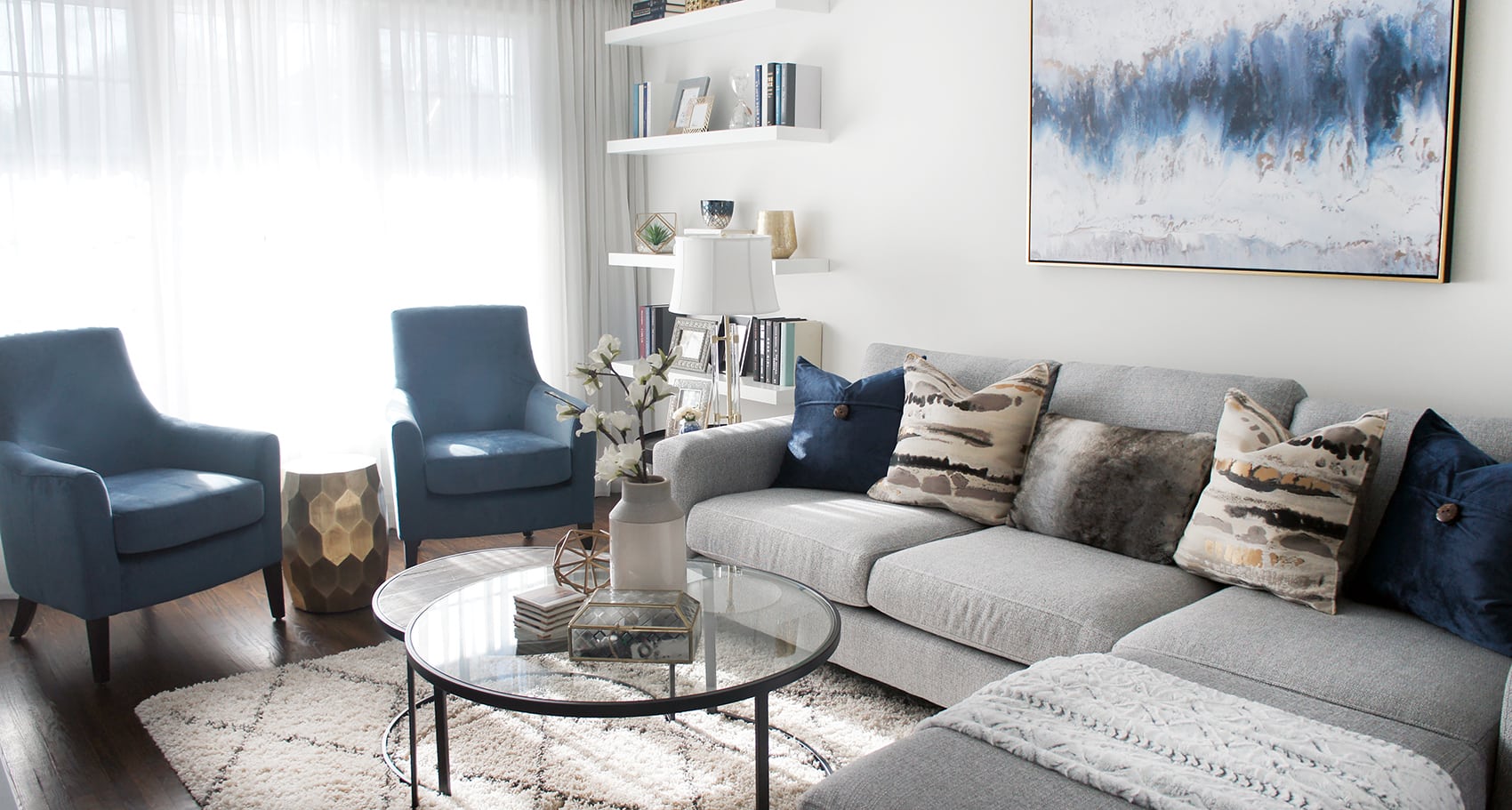 The mirror over the mantle adds height and echoes the geometry of the bordering cabinets