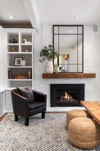 We painted out the brick and added a wall-mounted mantle that ties in the existing coffee table