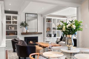 The mirror over the mantle adds height and echoes the geometry of the bordering cabinets