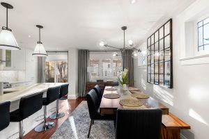 We kept the existing table in the dining area, but added a modern chandelier over it and new pendant lighting in the kitchen