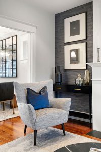 A play of texture between the rug, chair and wallpaper